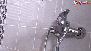Bathroom masturbation in sexy pantyhose from an inked beauty