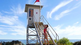 Stunning lifeguard posing on the beach