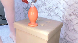 Slender girl was able to sit on a giant plug 10 cm wide