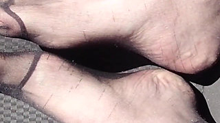 Feet of Nylonjunge in Pantyhose in Car
