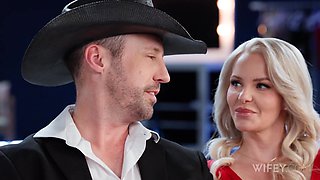 Hot blonde milf enjoys playing with her black friend's huge cock, sucking and riding it, while her boyfriend is watching her fun, sitting on the couch