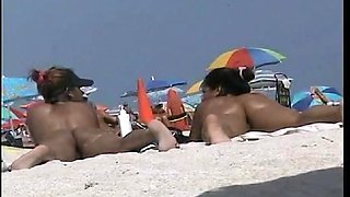 Amazing beach voyeur vid of two nudist girls and their wet pussies