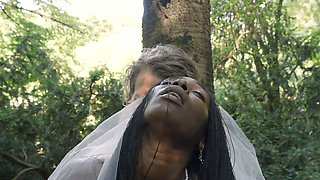 Black bride and a white groom are having sex in the woods