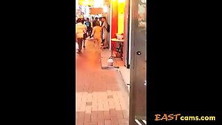 Asian woman stripped naked on street