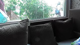Hairy mature flashing in front of window