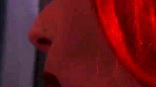 Redhead nurse sucks cock at a gloryhole