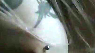 Tattooed teen is dancing in the dark room